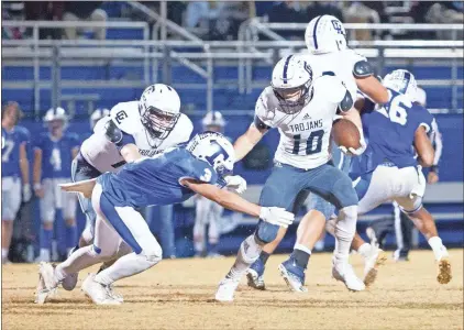  ?? Jan Wright ?? Gordon Lee’s Cade Peterson pushes away Trion’s Linkin Farrar during the Trojans’ 50-13 runaway victory over the Bulldogs Friday night in Trion. Peterson had 262 yards and four touchdowns on 25 carries.