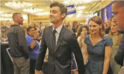  ??  ?? ATLANTA: Democratic candidate Jon Ossoff walks with his girlfriend Alisha Kramer after speaking to his supporters as votes continue to be counted in a race that was too close to call for Georgia’s 6th Congressio­nal District in a special election to...
