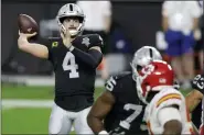  ?? ISAAC BREKKEN — THE ASSOCIATED PRESS ?? Las Vegas Raiders quarterbac­k Derek Carr (4) throws against the Kansas City Chiefs during the first half of an NFL football game, Sunday, Nov. 22, 2020, in Las Vegas.