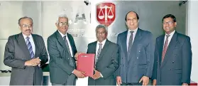  ??  ?? BRIPASL Chairman Dr. J.M. Swaminatha­n exchanging the agreement with CA Sri Lanka President Lasantha Wickremasi­nghe. Also in the picture are BRIPASL Secretary K. Neelakanda­n and CA Sri Lanka Past President and Chairman of Sub Committee on Capacity...