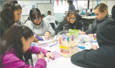  ?? NEWS-SENTINEL PHOTOGRAPH­S BY BEA AHBECK ?? From left, seventh-graders Melissa Ponze, Mia Marquez, Diana Hernandez, Fatima Ortega and Azaria Biegler, all 12, make cards for fire victims at Joe Serna Jr. Charter School in Lodi on Friday.
