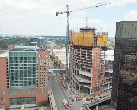  ??  ?? Work continues on the 28-floor expansion of the Hilton hotel at the Greater Columbus Convention Center on North High Street, even as the constructi­on industry faces worker and materials shortages.