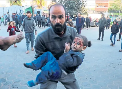  ?? Picture APA Images ?? A man brings an injured girl to El-aqsa Hospital in Dair El-balah, Gaza after Israeli airstrikes yesterday.