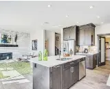  ??  ?? A dual sink and dishwasher are contained in the kitchen island, which faces the great room.