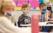  ?? PHOTO BY JOE RONDONE/THE COMMERCIAL APPEAL ?? Third grade students wear their masks as the 2020-21 school year begins at Forest Hill Elementary School in Germantown, Tenn.