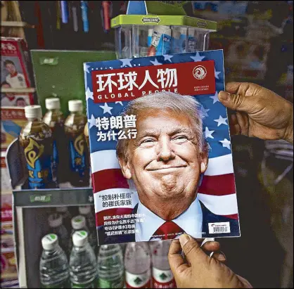  ?? AFP ?? Photo shows a copy of the local Chinese magazine Global People with a cover story that translates to ‘Why did Trump win’ at a news stand in Shanghai Friday. US president-elect Donald Trump broke with decades of cautious US diplomacy on Dec. 2 to speak...