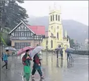  ??  ?? People taking a stroll during the rain on The Ridge in Shimla on Saturday. DEEPAK SANSTA / HT