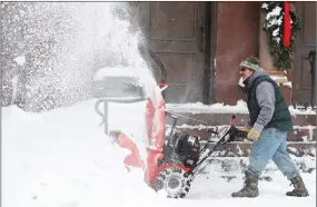  ?? TONY DEJAK ?? Frank Necci clears snow from St. Andrews Catholic Church, Friday, in Erie, Pa. The cold weather pattern was expected to continue through the holiday weekend and likely longer, according to the National Weather Service, prolonging a stretch of brutal...