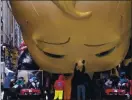  ?? CRAIG RUTTLE — THE ASSOCIATED PRESS ?? The Boss Baby balloon is deflated as it ends its appearance in the parade.