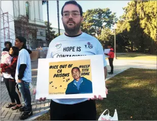  ?? DON THOMPSON — THE ASSOCIATED PRESS ?? Connor Gorman of Davis joins a rally on behalf of Cambodian refugee Tith Ton, who is awaiting parole from a murder conviction but could be deported to Cambodia, at the California Capitol in Sacramento on Nov. 1.