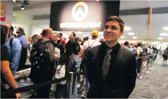  ??  ?? Pro Gamer Jake Lyon, of the Overwatch League’s Houston Outlaws, stands outside Overwatch Arena at BlizzCon, where he was interactin­g with fans — a standard part of the job requiremen­ts for many pro esports gamers.