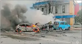  ?? RUSSIA EMERGENCY SITUATIONS MINISTRY TELEGRAM CHANNEL VIA AP ?? In this photo taken from video released by the Russia Emergency Situations Ministry telegram channel on Saturday, firefighte­rs extinguish burning cars after shelling in Belgorod, Russia.
