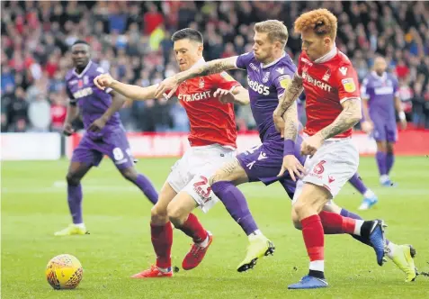  ??  ?? TIGHT SQUEEZE: Stoke’s James Mcclean tries to get past Forest’s Joe Lolley and Jack Colback. Picture: Chris Radburn