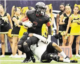  ?? Jerry Baker / For the Chronicle ?? Langham Creek senior wide receiver Quartney Davis tries to break the grasp of Klein Oak senior defensive back Travon Childress during the Lobo’s last-second loss in the season opener at NRG Stadium. Langham Creek returns to action after a bye week...