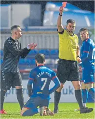 ??  ?? Rough justice? James Keatings goes down before, right, being shown a second yellow card for simulation