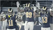  ?? L.G. PATTERSON/ASSOCIATED PRESS ?? From left, St. Louis Rams players, Stedman Bailey, Tavon Austin, Jared Cook, Chris Givens and Kenny Britt raise their arms Sunday in reference to the events in Ferguson, Mo.