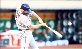  ??  ?? Houston Astros’ Evan Gattis connects for a three-run home run off Oakland Athletics’ Daniel Mengden during the
second inning of a baseball game on June 12, in Oakland, Calif. (AP)