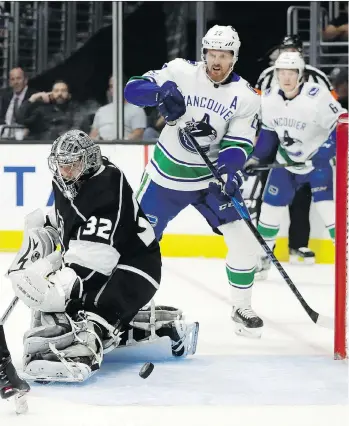  ?? CHRIS CARLSON/THE ASSOCIATED PRESS ?? Los Angeles Kings goaltender Jonathan Quick makes a save as Vancouver Canucks left wing Daniel Sedin looks on during the first period on Tuesday in Los Angeles.