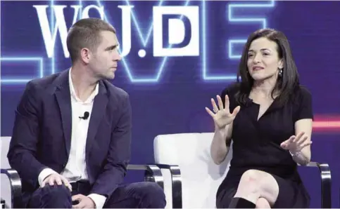  ?? —AP ?? LAGUNA BEACH, CALIFORNIA: Facebook chief product officer Chris Cox (L) and chief operating officer Sheryl Sandberg (R) discuss the leading social network at a WSJD Live technology conference on October 25, 2016.