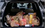  ?? BRITTANY GREESON — THE NEW YORK TIMES ?? Groceries are seen in the trunk of a car after a purchase at a Kroger Marketplac­e in Royal Oak, Mich., on Nov. 17, 2021.