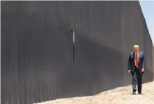  ?? Doug Mills / New York Times ?? President Trump walks along a section of border wall in San Luis, Ariz., in June. He tried to use military funds for the wall.