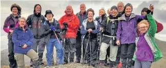  ??  ?? Reaching the top Members at the summit of 815m Beinn Each