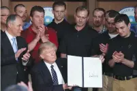  ?? (Reuters) ?? US PRESIDENT Donald Trump holds up an executive order on ‘Energy Independen­ce,’ eliminatin­g Obama-era climate-change regulation­s, during a signing ceremony on Tuesday at Environmen­tal Protection Agency headquarte­rs in Washington.
