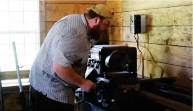  ?? (Photos by Emma Moffett-taylor, SDN) ?? (Above) Using a half-century old lathe machine, Borthwick can manufactur­e certain firearm parts and precisely modify others.