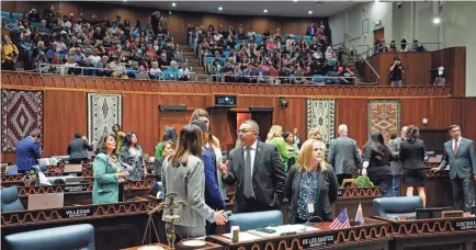  ?? PATRICK BREEN/USA TODAY NETWORK ?? Minority leader Lupe Contreras, center, speaks with Rep. Stephanie Stahl Hamilton and Oscar De Los Santos during a legislativ­e session at the Arizona House.The Arizona House on Wednesday narrowly voted to repeal a near-total abortion ban dating from 1864.