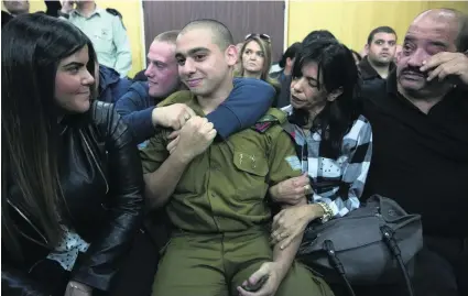  ?? Heidi Levine, Hazem Bader / AFP ?? Israeli soldier Elor Azaria laughs with his parents and his girlfriend Orel, left, as he waits for the verdict. Below, victim Abdul Fatah Al Sharif’s parents Rajaa and Yousri in Hebron after watching the court scenes on TV.