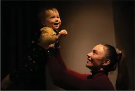  ?? (AP/Vadim Ghirda) ?? Yeva, a Ukrainian toddler who was born on Feb. 24, 2022, plays with her mother, Alina Mustafaiev­a, on Feb. 17 at their home in Kharkiv, Ukraine.