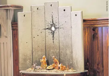  ??  ?? An artwork dubbed Scar Of Bethlehem by street artist Banksy displayed in the Walled Off hotel, in Bethlehem.