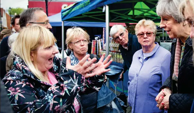  ??  ?? ‘I want you to do something’: Cathy Mohan challenges Theresa May about cuts to disability benefits during the visit to Abingdon yesterday