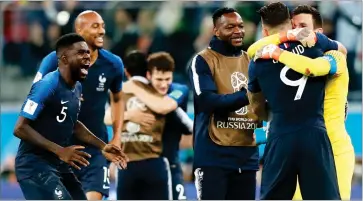  ?? AP PHOTO BY FRANK AUGSTEIN ?? France’s Samuel Umtiti, left, celebrates with team mates after the semifinal match between France and Belgium at the 2018 soccer World Cup in the St. Petersburg Stadium in, St. Petersburg, Russia, Tuesday, July 10.