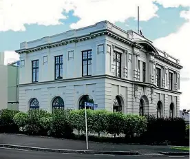  ??  ?? Left: The exterior of the Mt Eden council chambers, converted into an apartment. Right: Kate Lane’s navy velvet couch belonged to home’s previous owner, former All Black Marc Ellis.