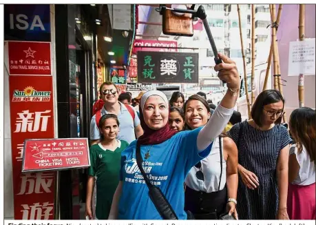  ??  ?? Finding their focus: Niaz (centre) taking a selfie with Squash Dreamers executive director Clayton Kier (back left), Squash Dreamers vice-president Rachel Lee (second right) and the girls in the team in Hong Kong.