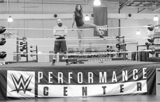  ?? RICH POPE/STAFF PHOTOGRAPH­ER ?? Stars-in-waiting: WWE NXT wrestlers Sylvester Lefort, left, and Billie Kay rehearse an entrance routine at the WWE Performanc­e Center in Orlando.