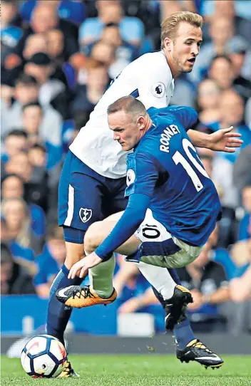  ??  ?? Centurion: Harry Kane, who has 101 Tottenham goals, stops Wayne Rooney