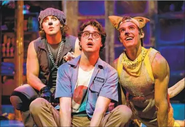  ?? Daren Scott ?? DOG SHELTER worker Eddie, center, played by Ryan McCartan, is f lanked by a pit bull named Bradley (Garrett Marshall), left, and a corgi named Digger (Ben Palacios) in “Mutt House” at the Kirk Douglas Theatre.