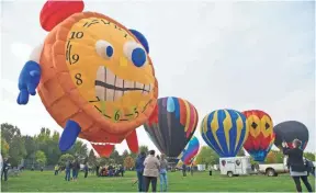  ?? GREG LEHMAN, AP ?? Balloons were grounded by high winds Thursday at the Balloon Stampede in Walla Walla, Wash., but several were inflated for attendees to enjoy.