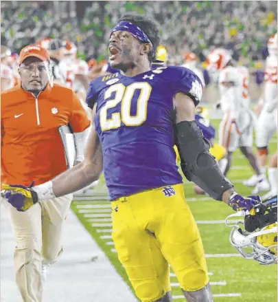  ?? Matt Cashore The Associated Press ?? Notre Dame safety Shaun Crawford is elated after his team’s 47-40 double-overtime victory over Clemson, ending the Tigers’ regular-season win streak at 36.