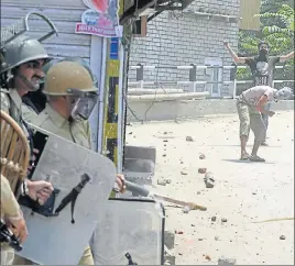  ?? AFP ?? Protesters pelt stones at security forces during clashes in Srinagar on Saturday. Apart from a few incidents of stone pelting, the first death anniversar­y of Hizbul Mujahideen militant Burhan Wani passed off without any major protest, authoritie­s said....