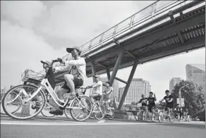  ?? ZHANG XIANDA / FOR CHINA DAILY ?? Residents of Huai'an in East China's Jiangsu province ride Hellobike bicycles.