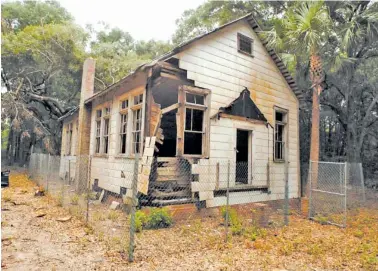  ?? PHOTOS BY BOBBY HAVEN/THE BRUNSWICK NEWS VIA AP ?? Preservati­onists saved the 1920s-era Harrington School on St. Simons Island, Ga., from scheduled demolition in 2010 and since then have spent about $300,000 to stabilize its deteriorat­ing frame and leaky roof.