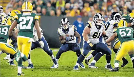  ?? Matt Ludtke Associated Press ?? ROOKIE JUSTIN DAVIS, making one last preseason push to land a roster spot, rushed for 55 yards in 17 carries against the Packers.