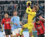  ?? – AFP ?? ROME: Lazio’s Italian goalkeeper #94 Ivan Provedel makes a save during the Italian Serie A football match between Lazio and AC Milan at the Olympic stadium in Rome.