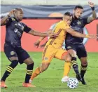  ?? MICHAEL WYKE/AP ?? The Crew’s Darlington Nagbe, left, and Artur, right, pressure Houston’s Darwin Ceren on Saturday night in Houston.