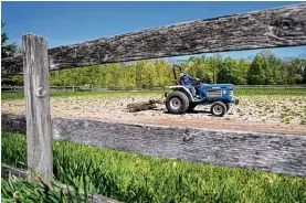  ?? ADAM CAIRNS / COLUMBUS DISPATCH ?? Rep. Mary Lightbody, D-Westervill­e, uses a tractor to clean up weeds from the horse area on her farm in Westervill­e. Lightbody sponsored House Bill 95, which aims to keep farmland in the hands of farmers by offering $10 million in tax breaks to retiring farmers who sell their property to aspiring farmers.