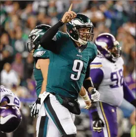 ?? ABBIE PARR / GETTY IMAGES ?? Eagles quarterbac­k Nick Foles completed 26 of 33 passes for 352 yards and three TDs on Sunday. He joined Joe Montana as the only quarterbac­ks in NFL history to complete 75 percent of their passes in consecutiv­e playoff games.