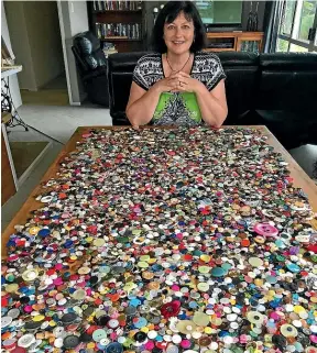  ?? JENNY LING/STUFF ?? Marina Young, who had an abortion aged 20, with thousands of buttons sent to her by women who have been through the procedure.